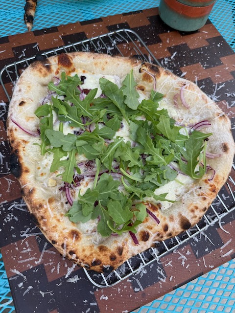 The Cutting Board pizza fresh out of the wood-fired oven